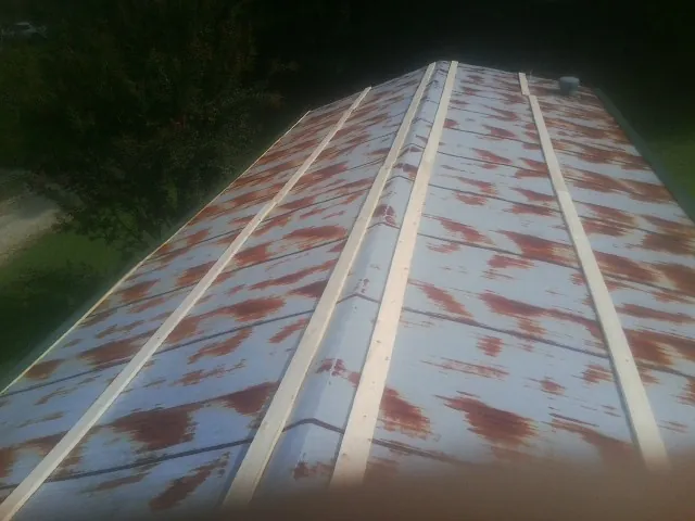 Rusted metal roof panels with new wood purlins before replacement — Storm Damage Roof Repair in Brooklet by Roofing Brothers